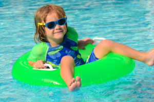 Photo of a Child floating in a swimming pool 